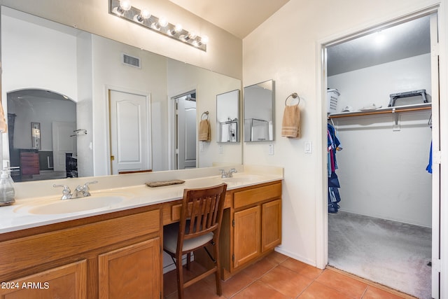 bathroom with dual sinks, tile floors, and large vanity