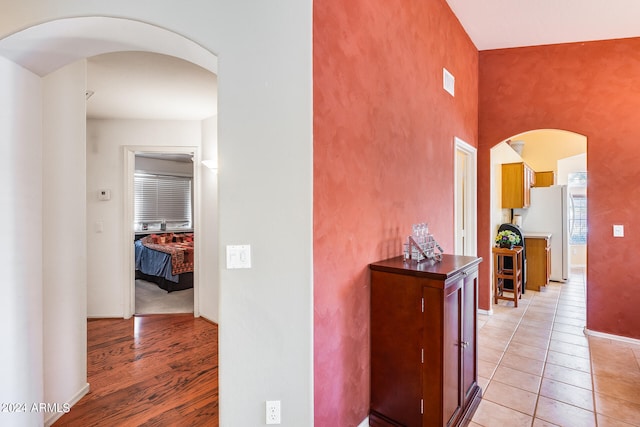 hall featuring light tile flooring