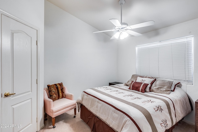 carpeted bedroom with ceiling fan and vaulted ceiling