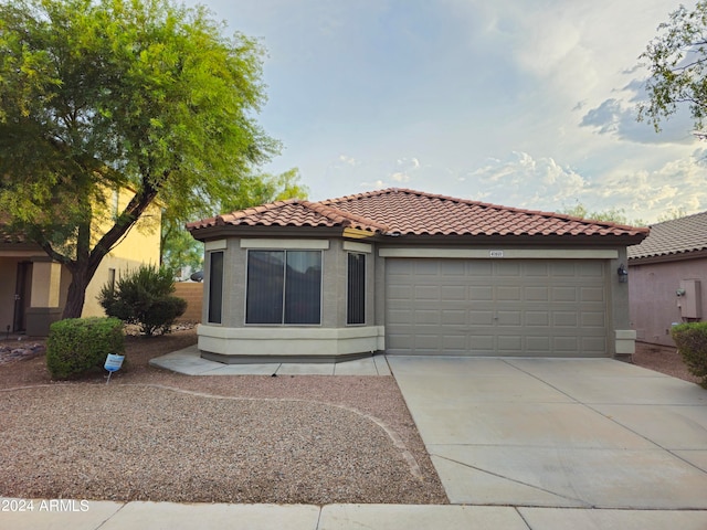 mediterranean / spanish-style home featuring a garage