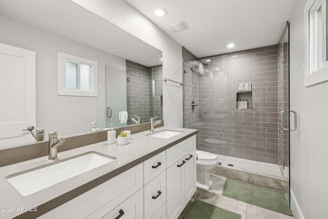 bathroom with walk in shower, tile patterned floors, vanity, and toilet