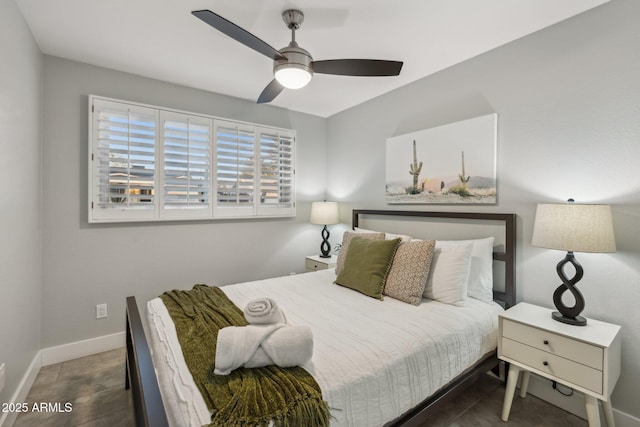 bedroom featuring dark tile patterned floors and ceiling fan