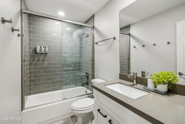 full bathroom with vanity, shower / bath combination with glass door, and toilet