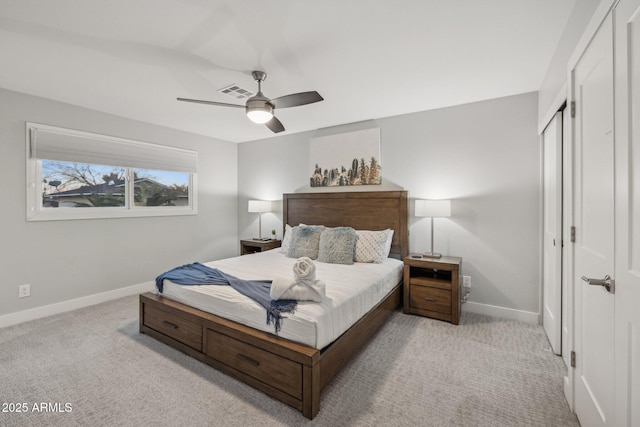 bedroom with ceiling fan, light colored carpet, and a closet