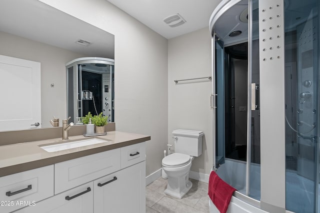 bathroom with vanity, an enclosed shower, tile patterned flooring, and toilet