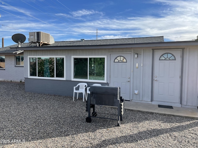 back of house featuring cooling unit