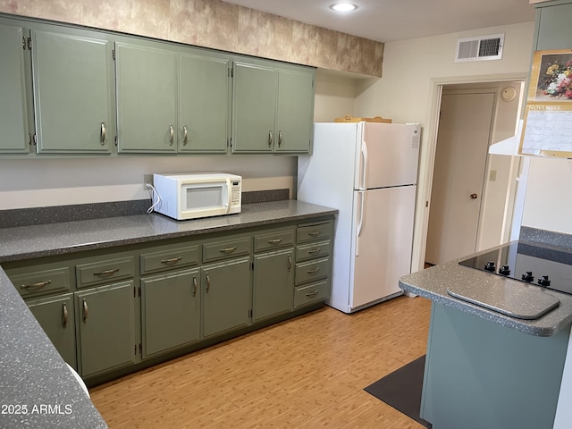 kitchen with white appliances, light hardwood / wood-style floors, and green cabinetry