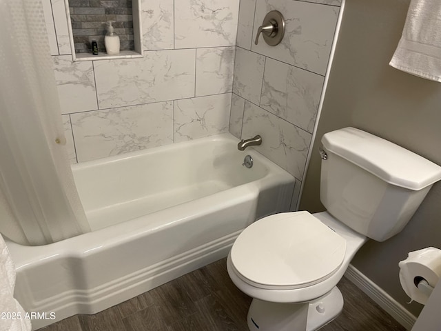 bathroom with hardwood / wood-style flooring, shower / tub combo with curtain, and toilet