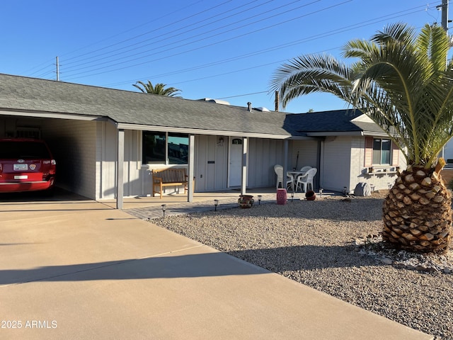 single story home with a carport and covered porch