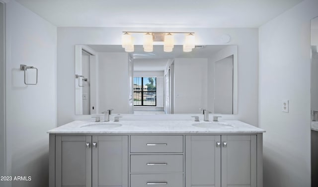 full bathroom featuring double vanity, a sink, and visible vents