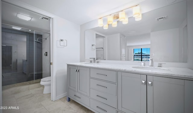 bathroom featuring a shower stall, visible vents, and a sink