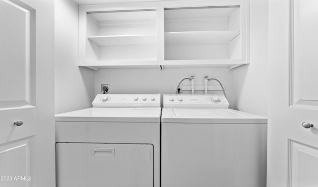 clothes washing area with laundry area and washing machine and clothes dryer