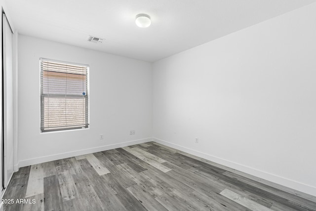 1750 E Desert Rose Trl, San Tan Valley, AZ 85143 - empty room with baseboards, visible vents, and wood finished floors