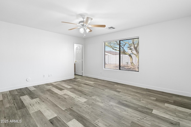 1750 E Desert Rose Trl, San Tan Valley, AZ 85143 - empty room featuring baseboards, visible vents, ceiling fan, and wood finished floors