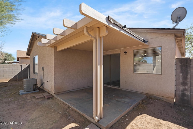 1750 E Desert Rose Trl, San Tan Valley, AZ 85143 - view of side of property featuring central AC unit, stucco siding, fence, and a patio