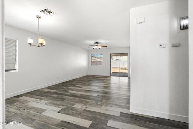 1750 E Desert Rose Trl, San Tan Valley, AZ 85143 - spare room featuring ceiling fan with notable chandelier, visible vents, wood finished floors, and baseboards