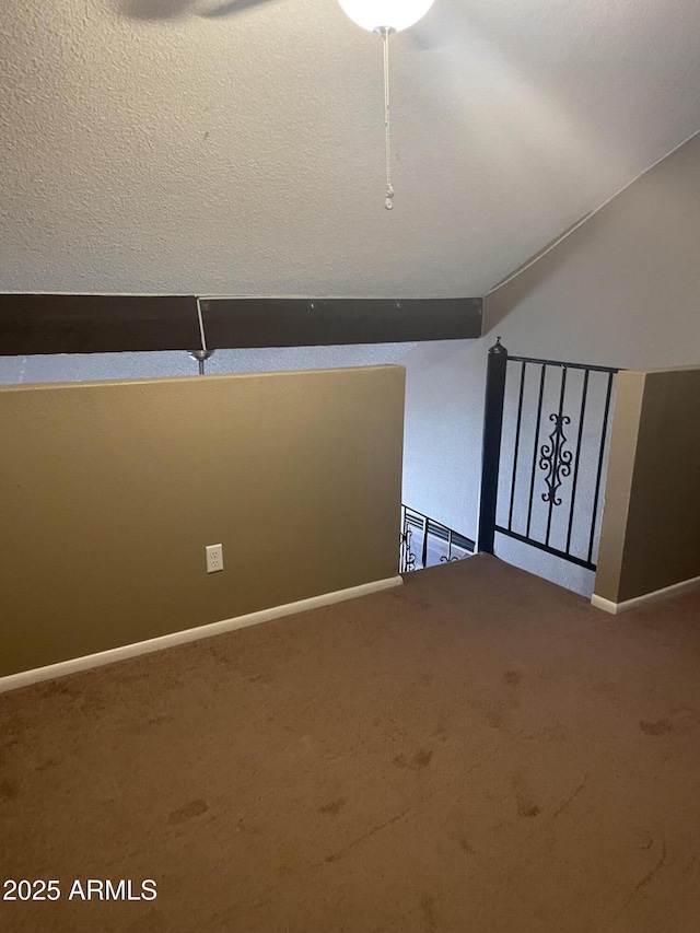 bonus room featuring baseboards and carpet