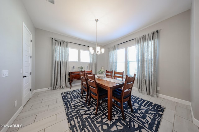 dining area featuring baseboards, light tile patterned floors, visible vents, and an inviting chandelier