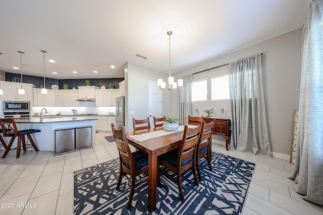 dining room with a chandelier, light tile patterned flooring, recessed lighting, visible vents, and baseboards