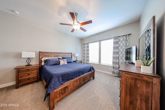 bedroom with vaulted ceiling, light carpet, ceiling fan, and baseboards