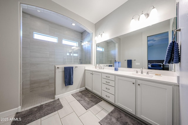 ensuite bathroom featuring a sink, double vanity, walk in shower, and ensuite bath