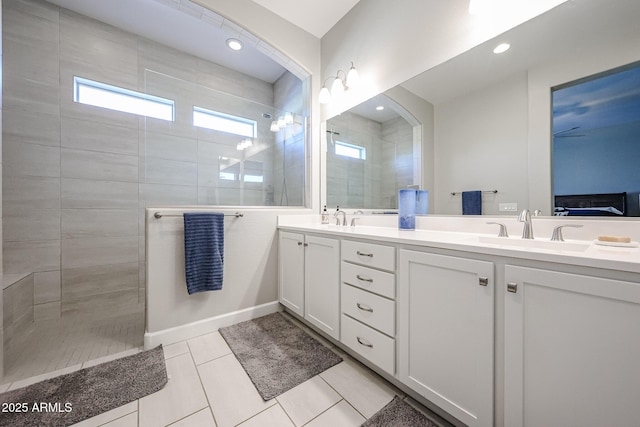 ensuite bathroom featuring a walk in shower, double vanity, a sink, and connected bathroom