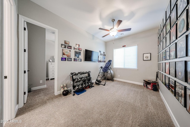 interior space with carpet, visible vents, baseboards, and ceiling fan