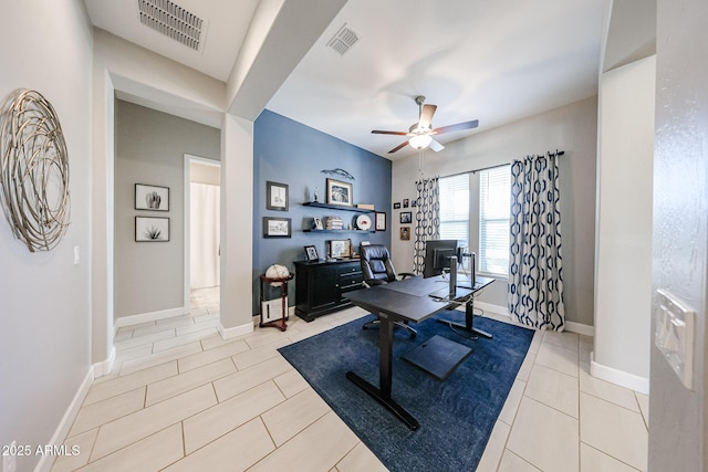 office area featuring a ceiling fan, visible vents, baseboards, and light tile patterned flooring