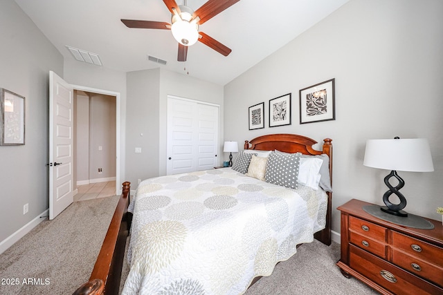 carpeted bedroom featuring a closet, visible vents, and baseboards