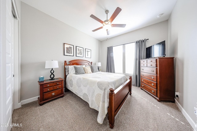 bedroom with ceiling fan, baseboards, and light colored carpet