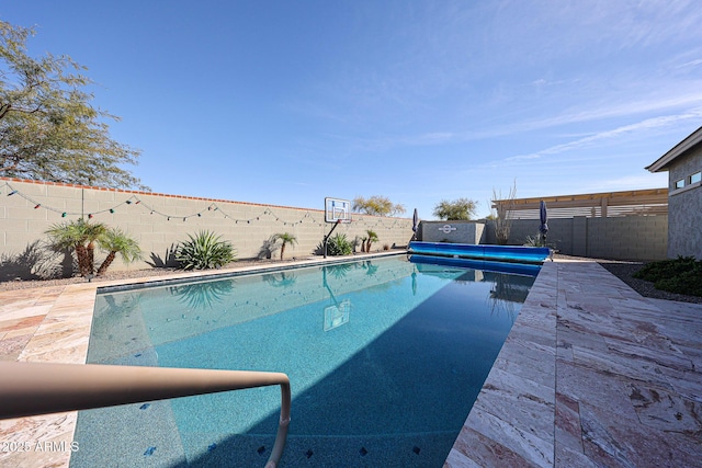 view of swimming pool featuring a patio area, a fenced backyard, and a fenced in pool