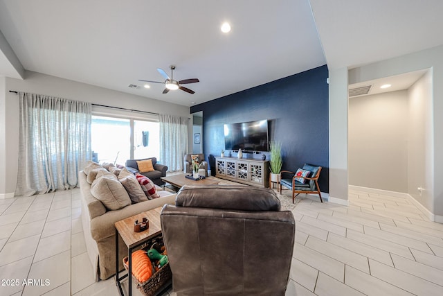 living room with visible vents, baseboards, a ceiling fan, and light tile patterned flooring