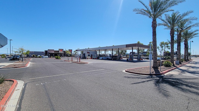 view of road featuring street lights and curbs
