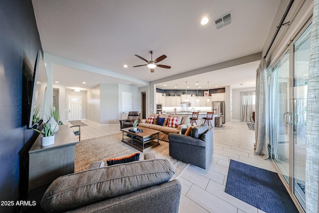 living room featuring recessed lighting, visible vents, light tile patterned flooring, ceiling fan, and baseboards