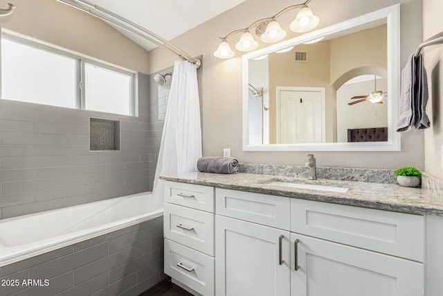 bathroom featuring ceiling fan, vanity, shower / tub combo, and lofted ceiling