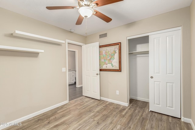 unfurnished bedroom featuring a closet, ceiling fan, and light wood-type flooring