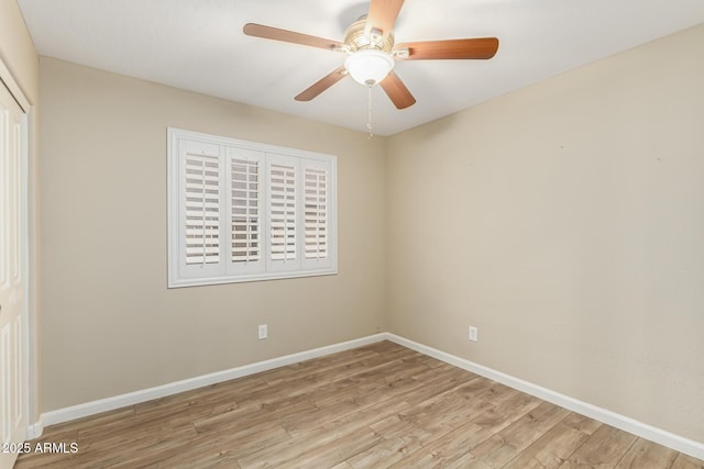 empty room with ceiling fan and light wood-type flooring