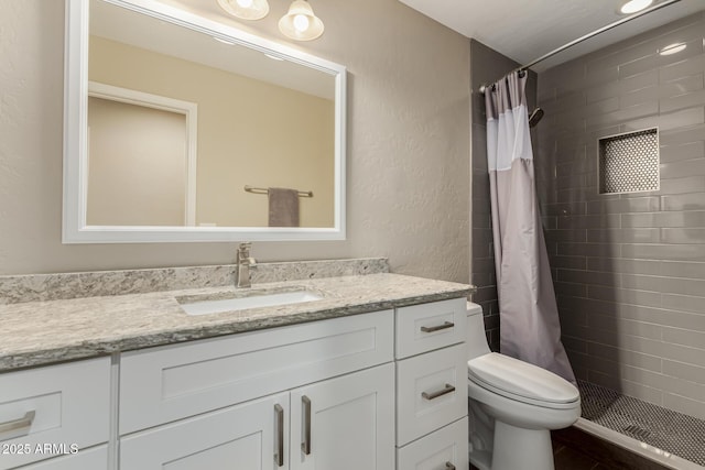 bathroom with vanity, toilet, and curtained shower