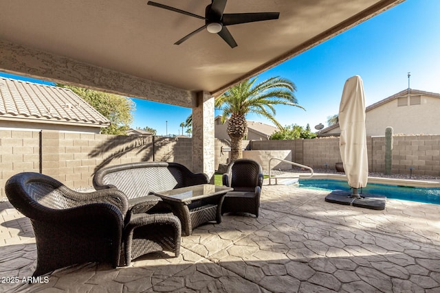 view of patio featuring a fenced in pool and ceiling fan