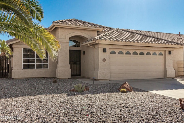 mediterranean / spanish-style home with a garage