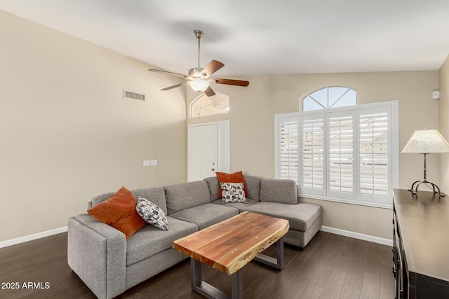 living room featuring vaulted ceiling, dark hardwood / wood-style floors, a wealth of natural light, and ceiling fan