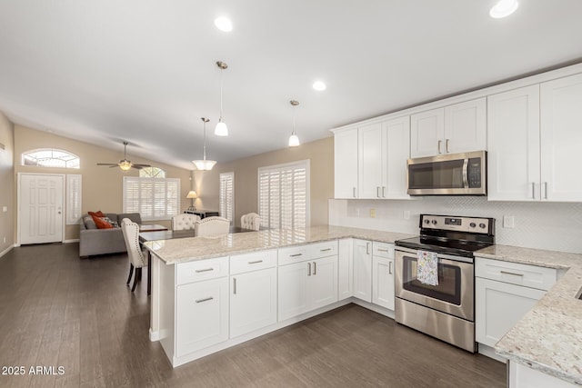 kitchen with white cabinetry, hanging light fixtures, kitchen peninsula, and appliances with stainless steel finishes