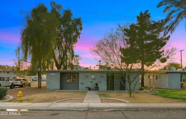 view of front facade featuring concrete block siding