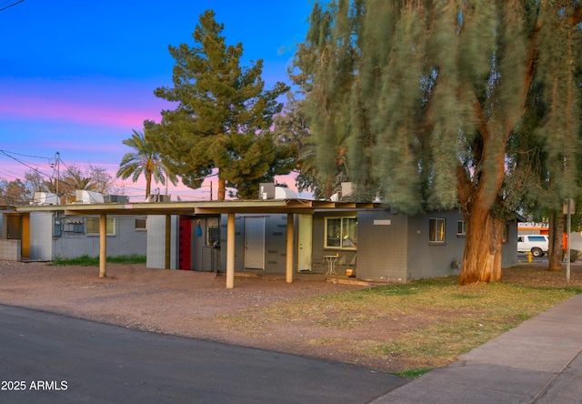 single story home with concrete block siding