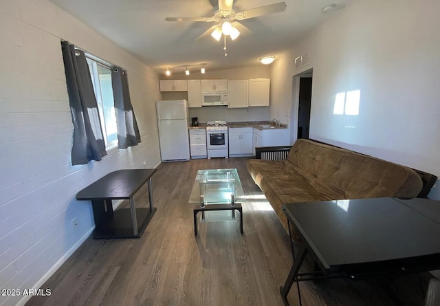 living room featuring dark wood-style floors, visible vents, and a ceiling fan