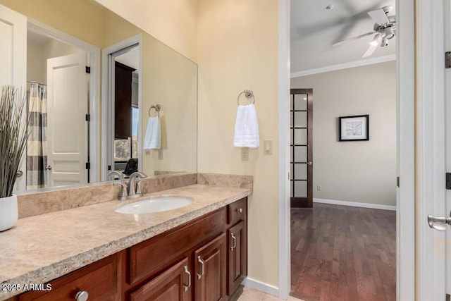 16540 E El Lago Blvd Unit 2, Fountain Hills, AZ 85268 - full bath with vanity, ornamental molding, baseboards, wood finished floors, and ceiling fan