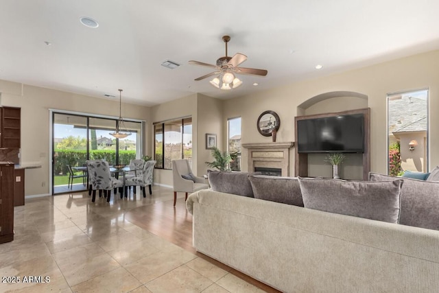 16540 E El Lago Blvd Unit 2, Fountain Hills, AZ 85268 - living room featuring baseboards, a fireplace, ceiling fan, light tile patterned floors, and recessed lighting