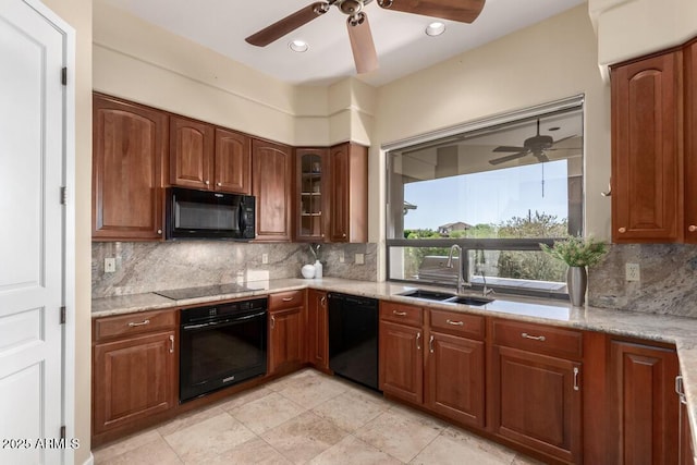 16540 E El Lago Blvd Unit 2, Fountain Hills, AZ 85268 - kitchen with black appliances, a sink, ceiling fan, backsplash, and light stone countertops