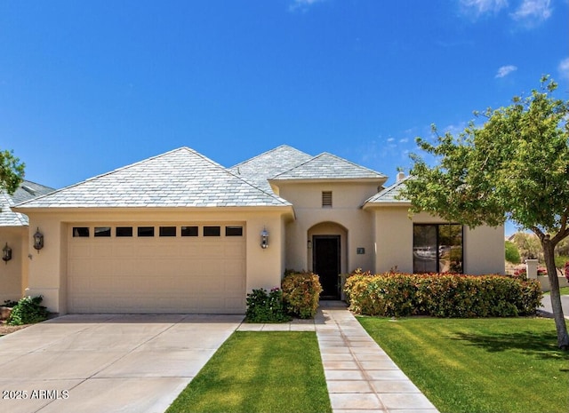 16540 E El Lago Blvd Unit 2, Fountain Hills, AZ 85268 - view of front of home with a garage, stucco siding, a front lawn, driveway, and a high end roof