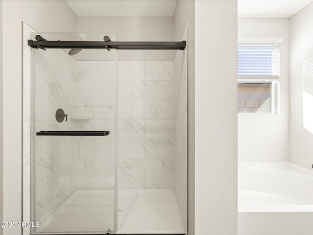 bathroom featuring shower with separate bathtub